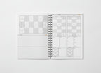 Open notebook with grid layout on a white background and soccer field